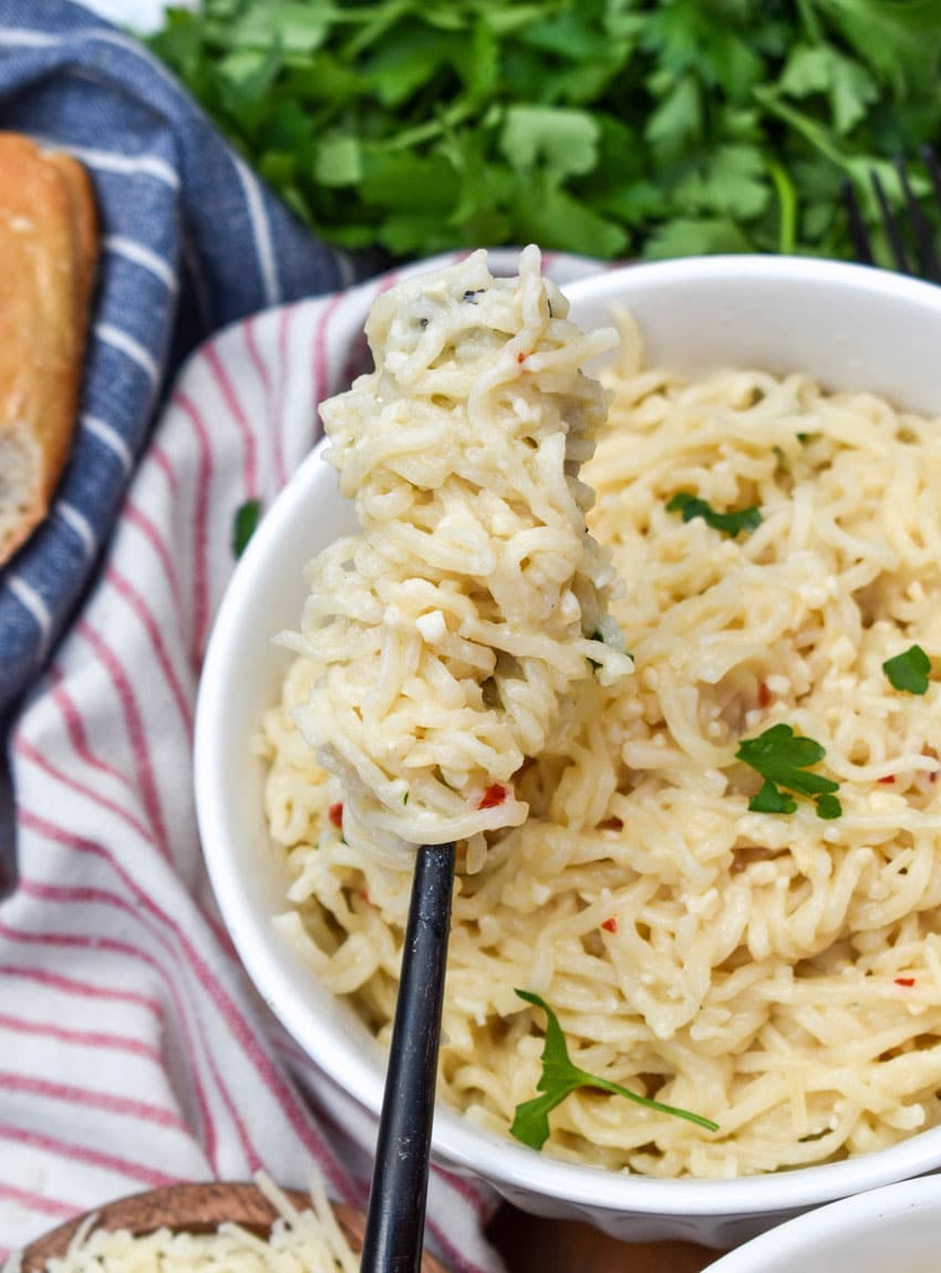 creamy garlic parmesan ramen noodles wrapped around a black fork