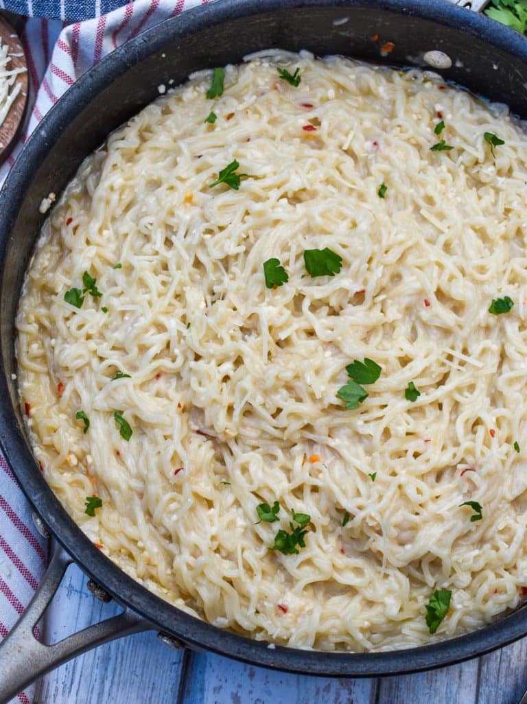 garlic parmesan ramen noodles in a large black skillet
