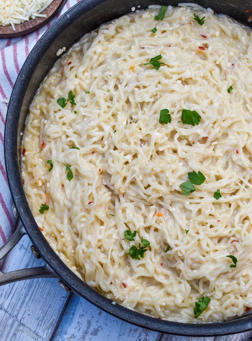 garlic parmesan ramen noodles in a large black skillet