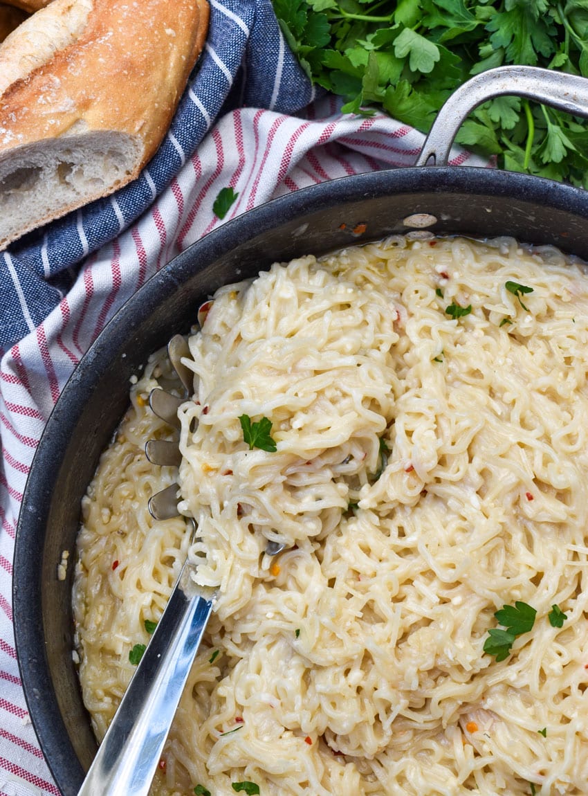 garlic parmesan ramen noodles in a large black skillet
