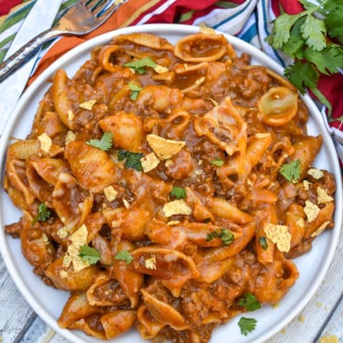 cheesy enchilada pasta on a white plate