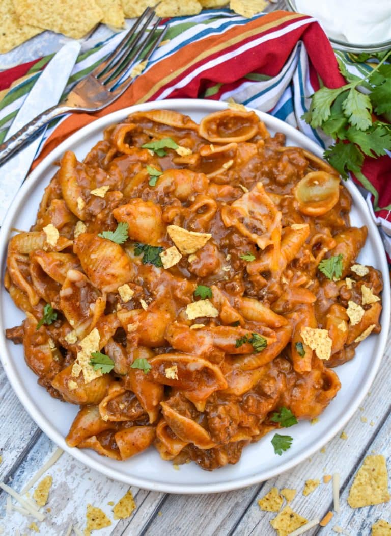 cheesy enchilada pasta on a white plate