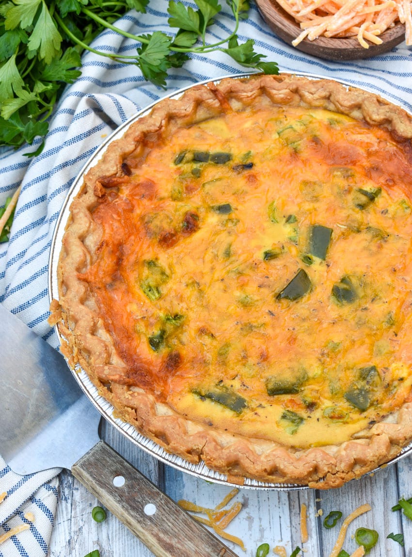 a philly cheesesteak quiche on a wooden table