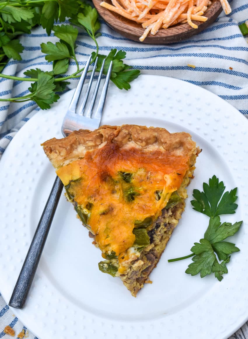a slice of philly cheesesteak quiche on a white plate