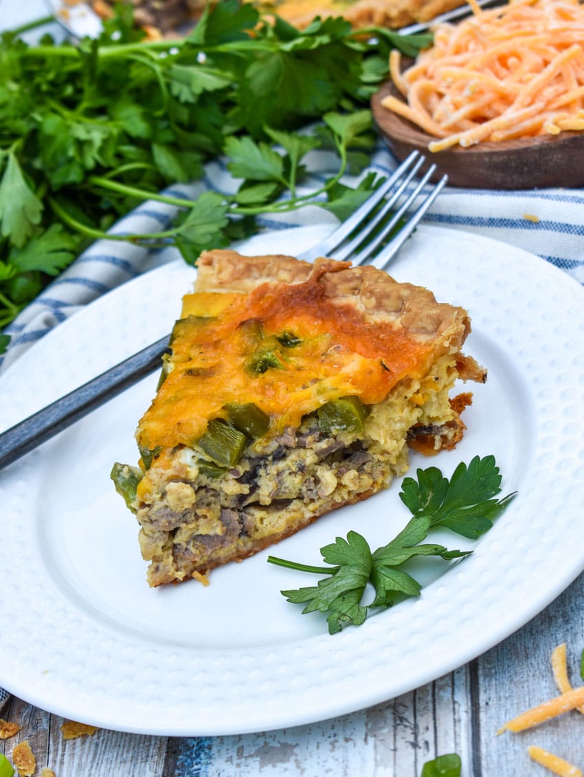 a slice of philly cheesesteak quiche on a white plate
