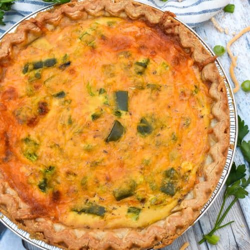 a philly cheesesteak quiche on a wooden table