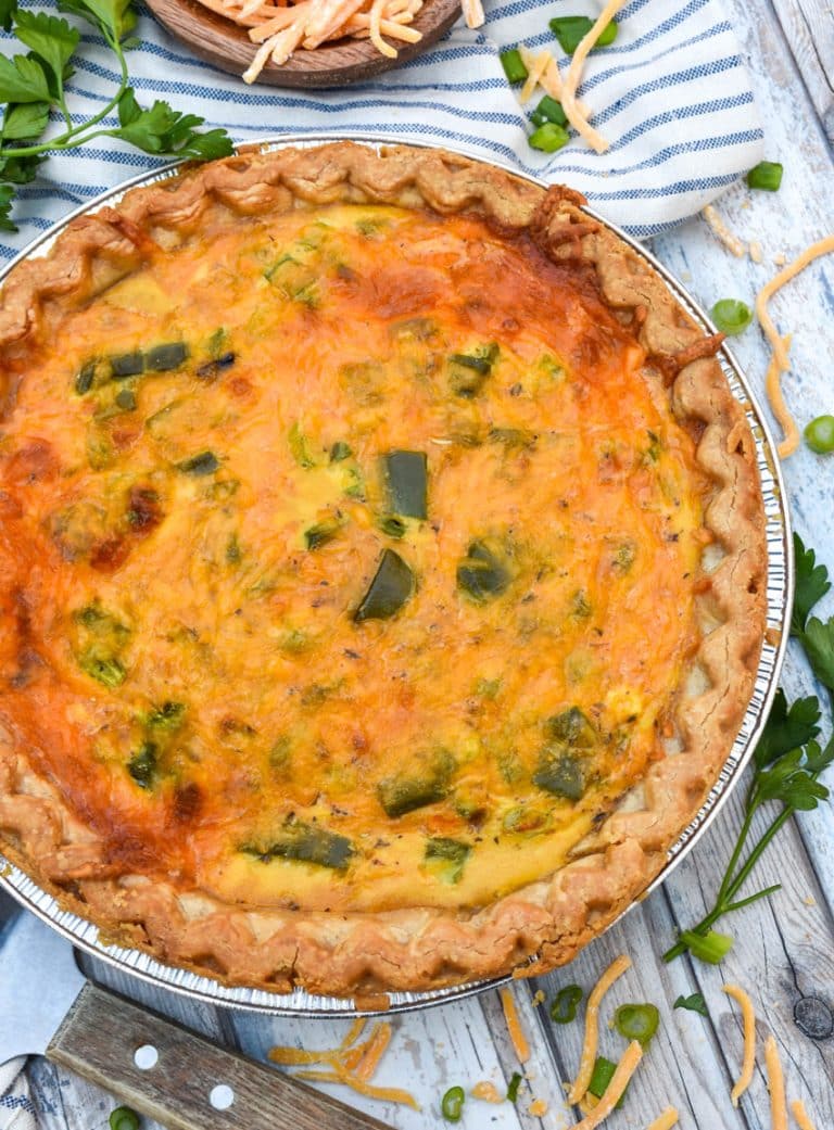 a philly cheesesteak quiche on a wooden table