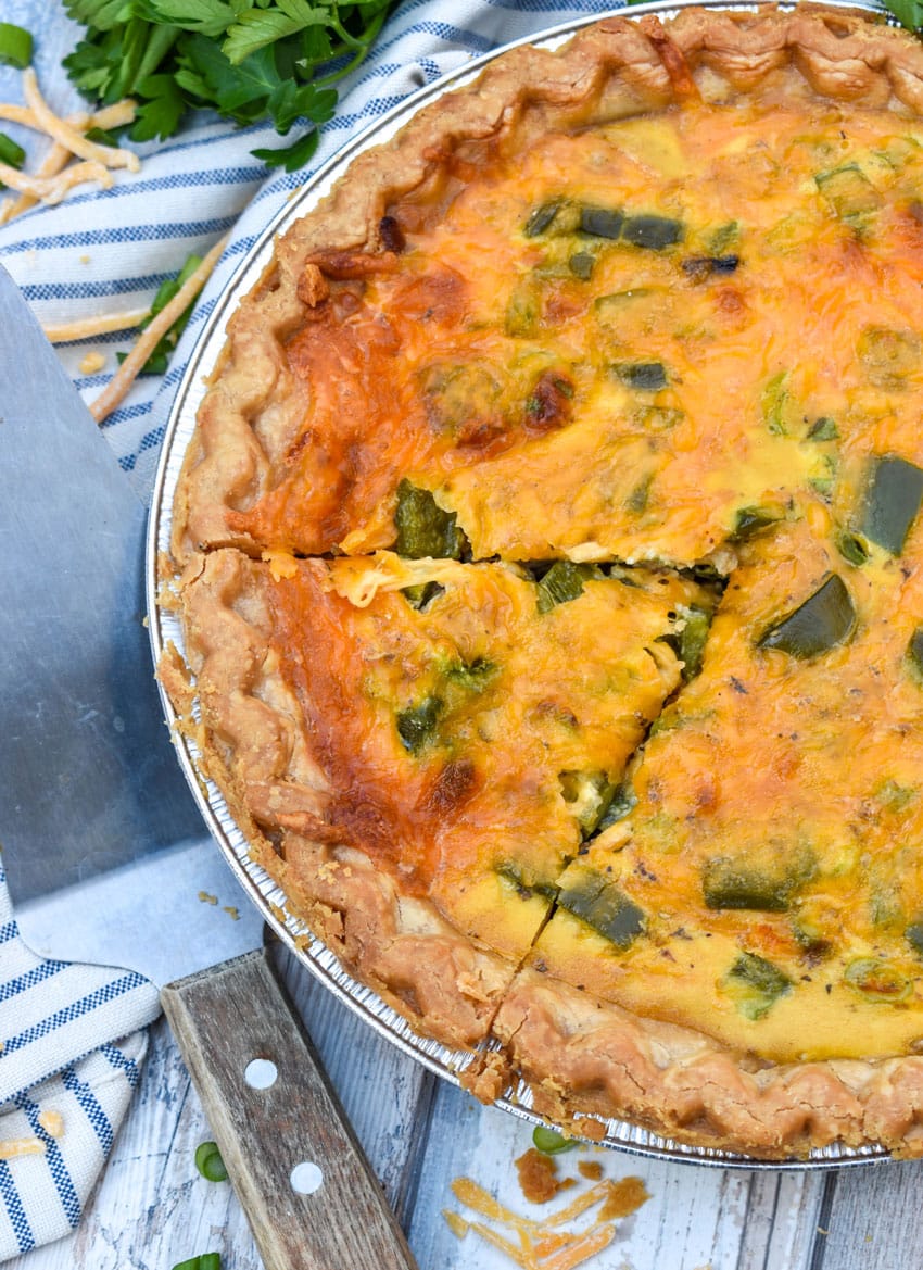 a philly cheesesteak quiche on a wooden table