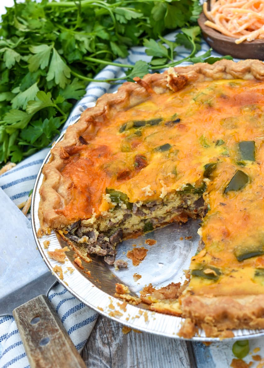 a philly cheesesteak quiche on a wooden table