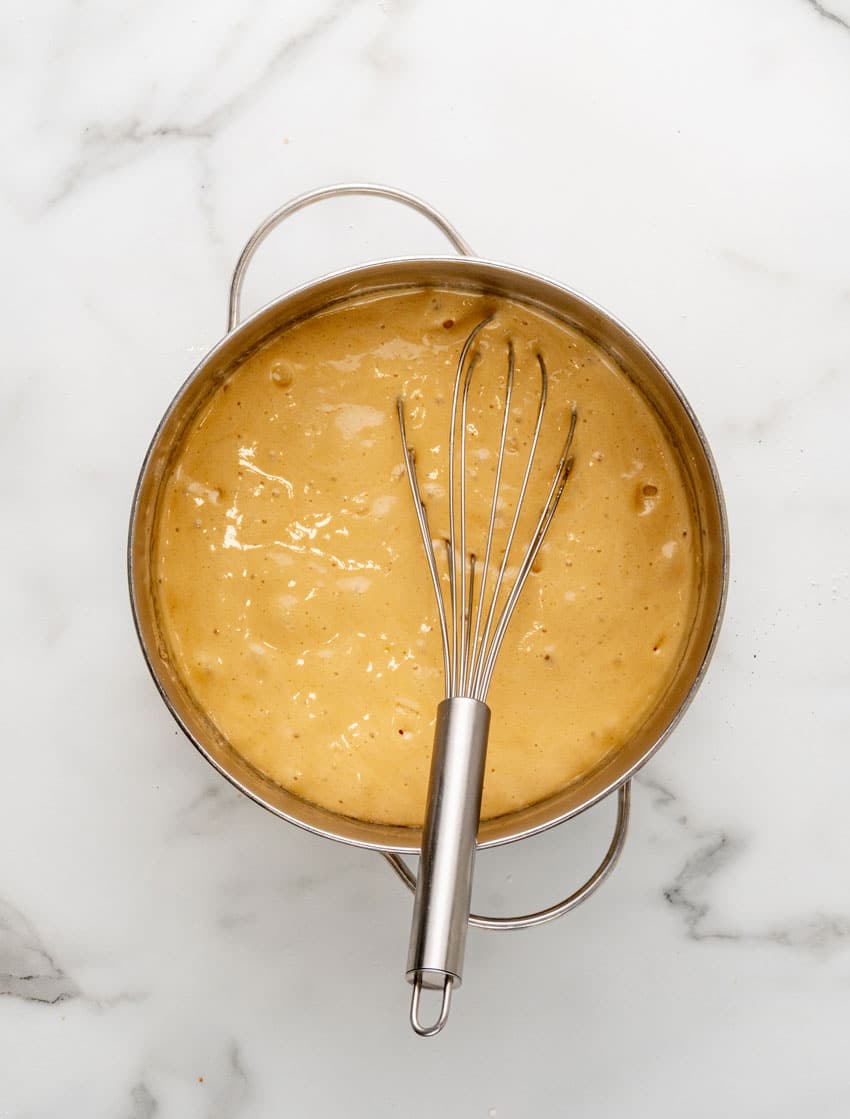 homemade caramel sauce bubbling in a metal sauce pan