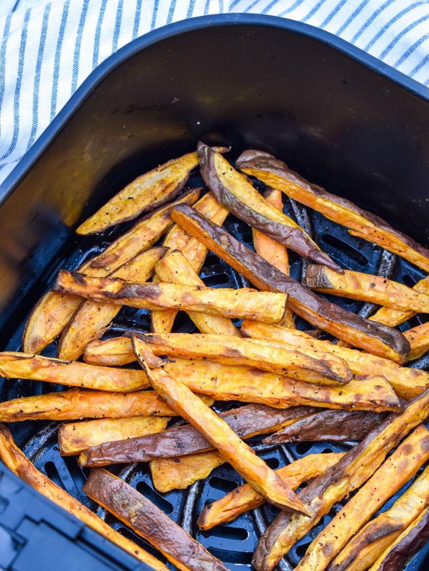 crispy cooked sweet potato fries in the basket of an air fryer