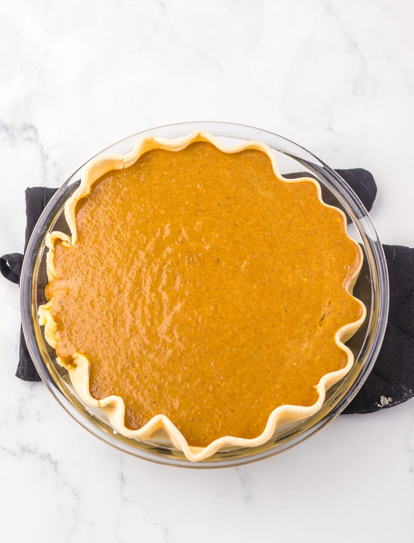 apple butter pie filling in a homemade pie crust in a glass baking dish