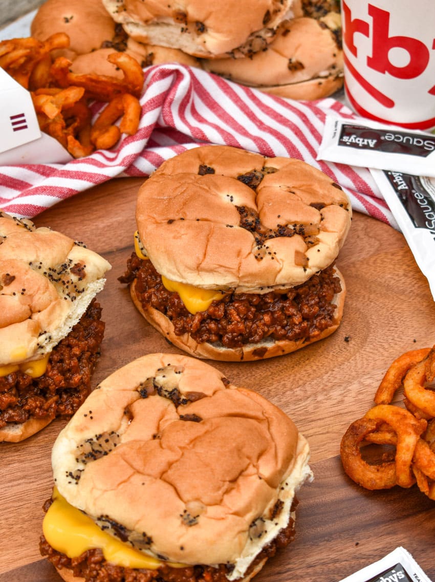 arby's beef n cheddar sloppy joes on a wooden serving tray