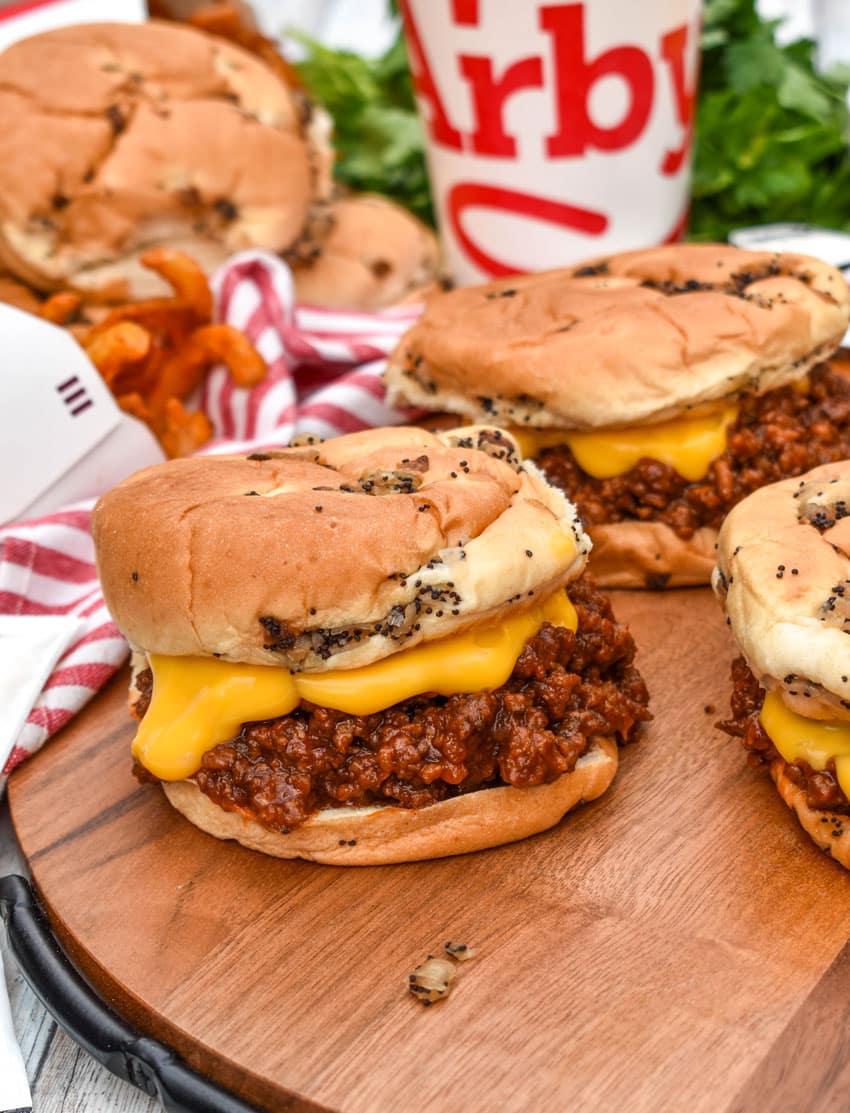 arby's beef n cheddar sloppy joes on a wooden serving tray