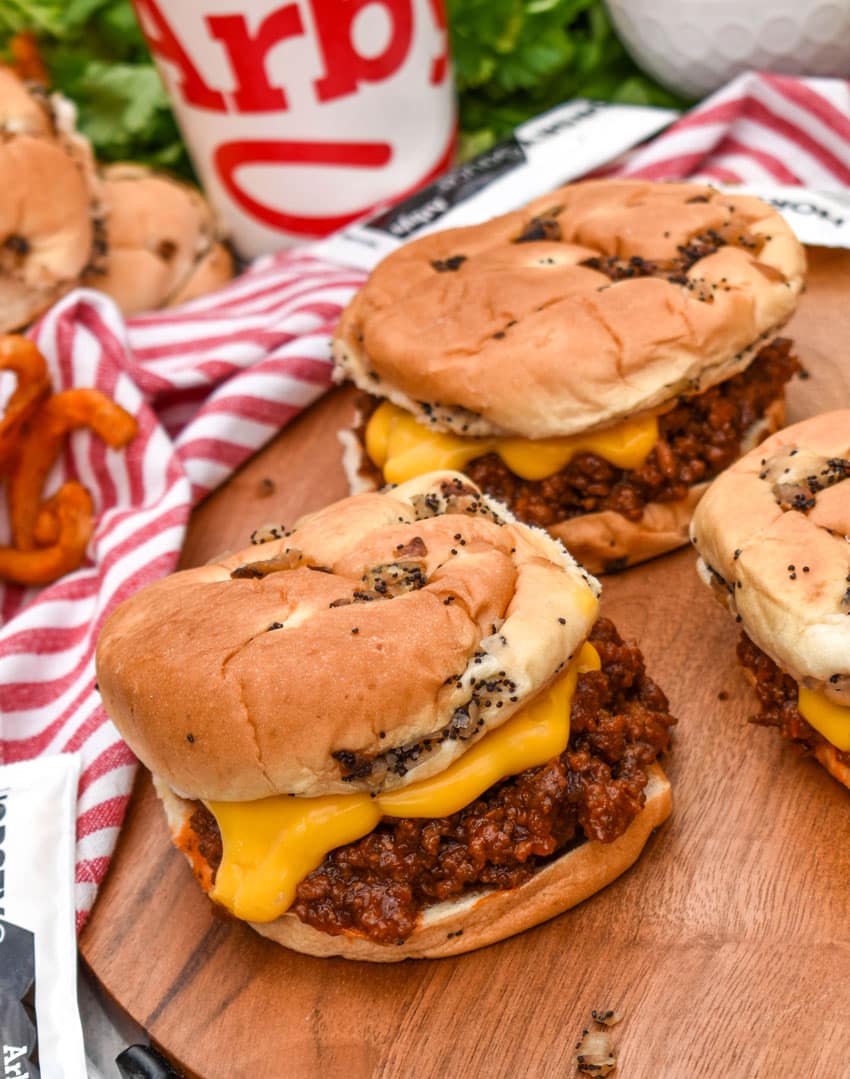 arby's beef n cheddar sloppy joes on a wooden serving tray