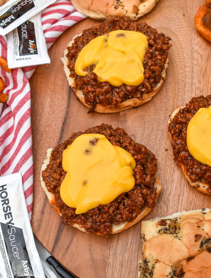 arby's beef n cheddar sloppy joes on a wooden serving tray