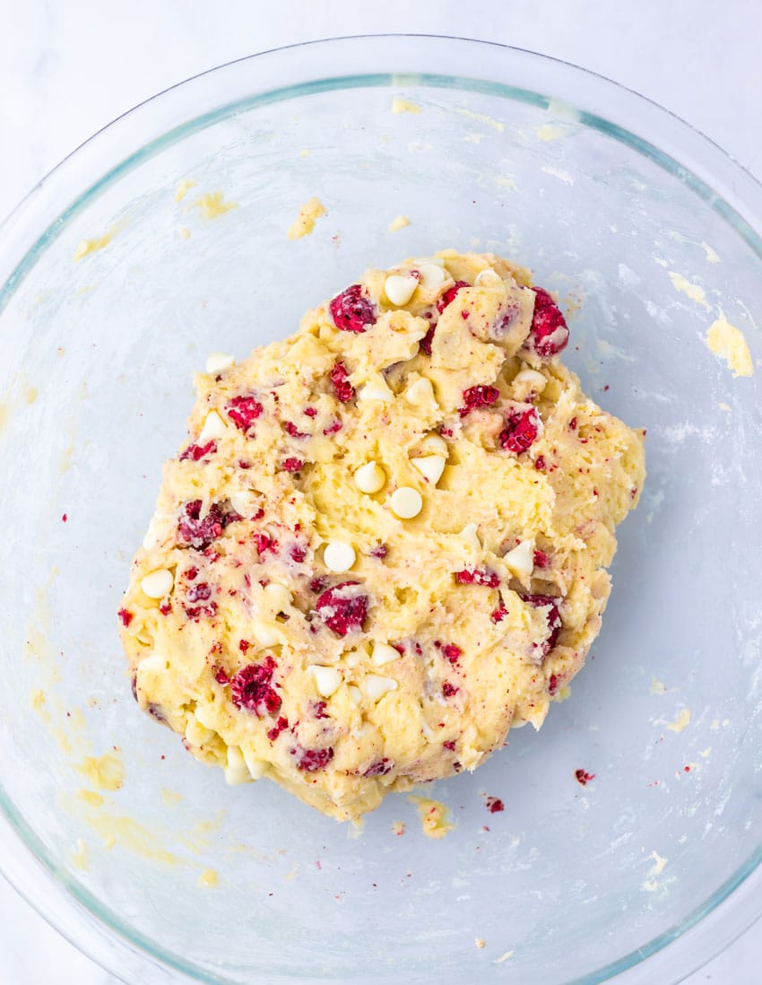 raspberry cheesecake cookie dough in a glass mixing bowl