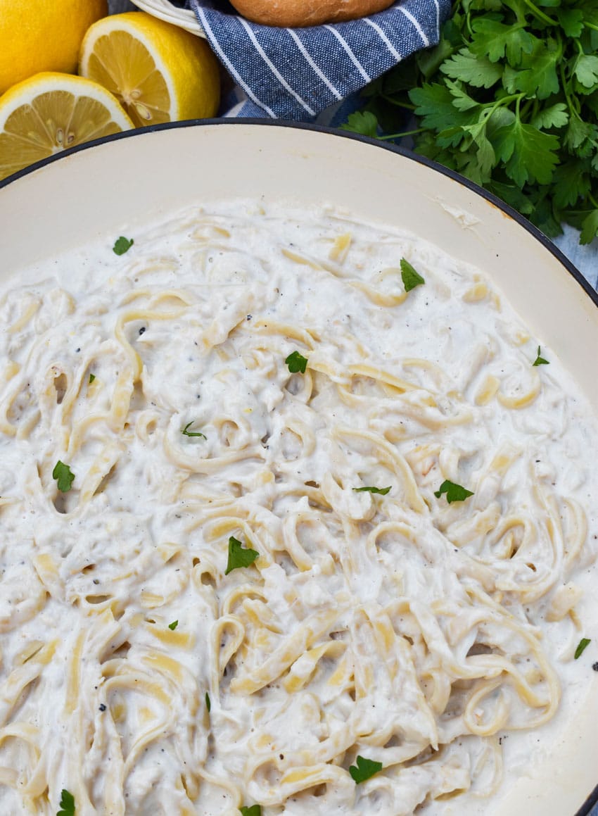 creamy crab pasta in a large cast iron skillet