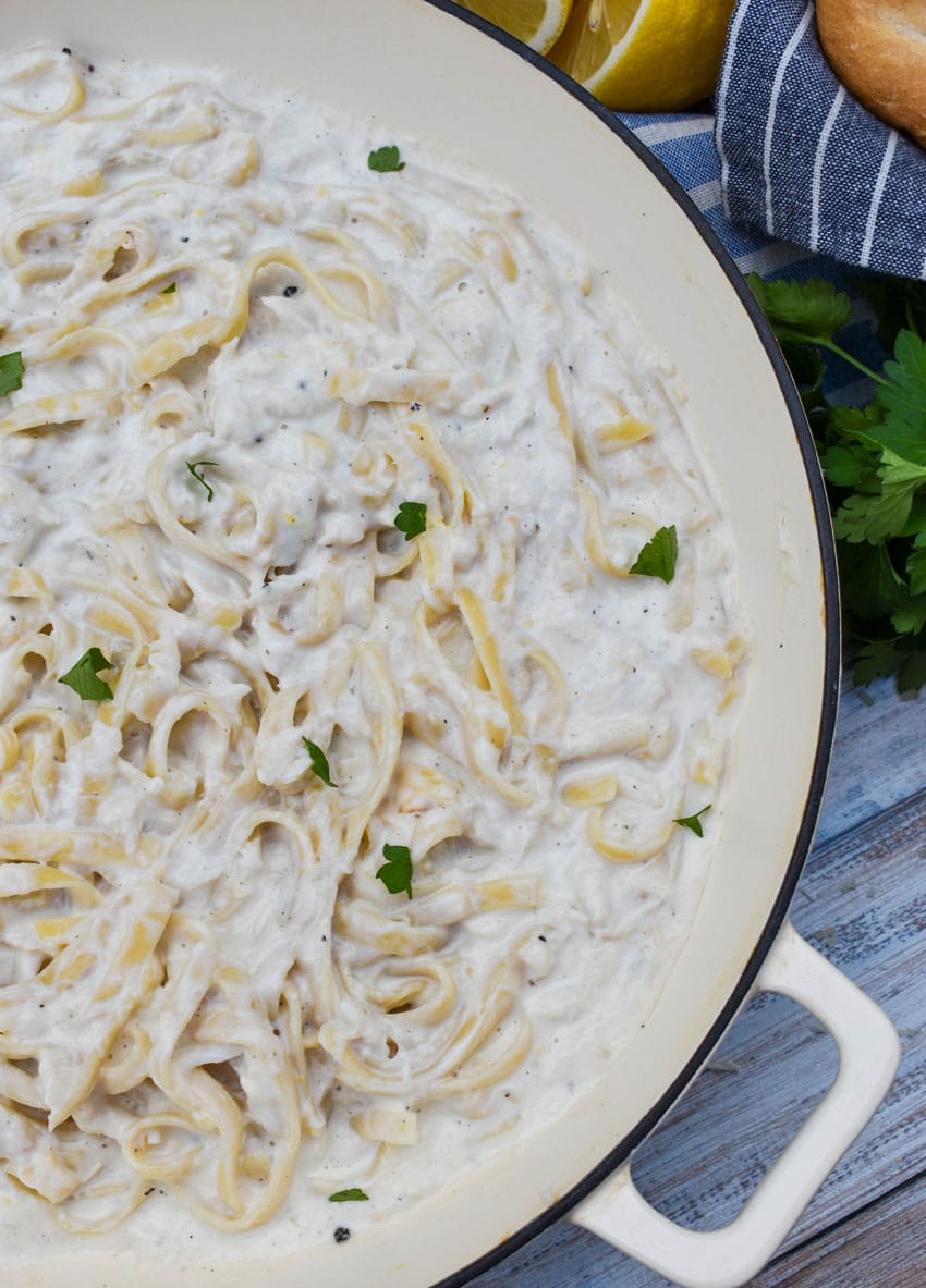 creamy crab pasta in a large cast iron skillet