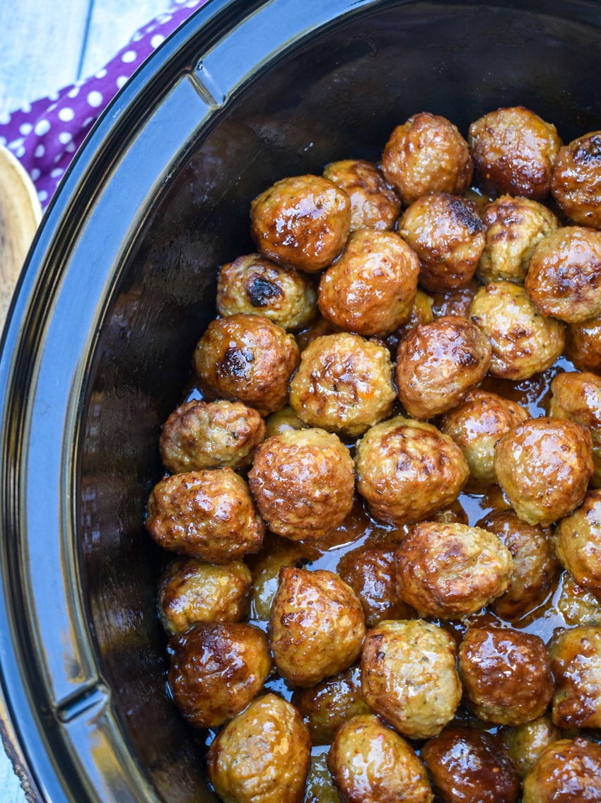 hot honey meatballs in the black bowl of a slow cooker
