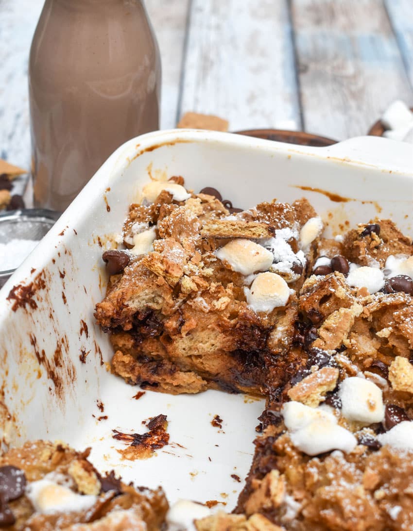 a cut s'mores french toast casserole in a white square baking dish