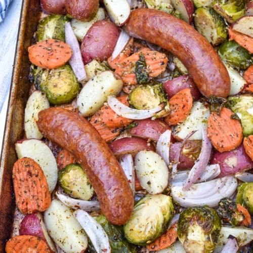 spicy Italian Sausage and roasted Vegetables on a metal baking sheet