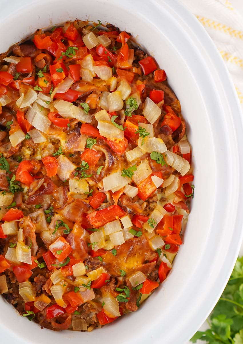 baked breakfast casserole in the white bowl of a slow cooker