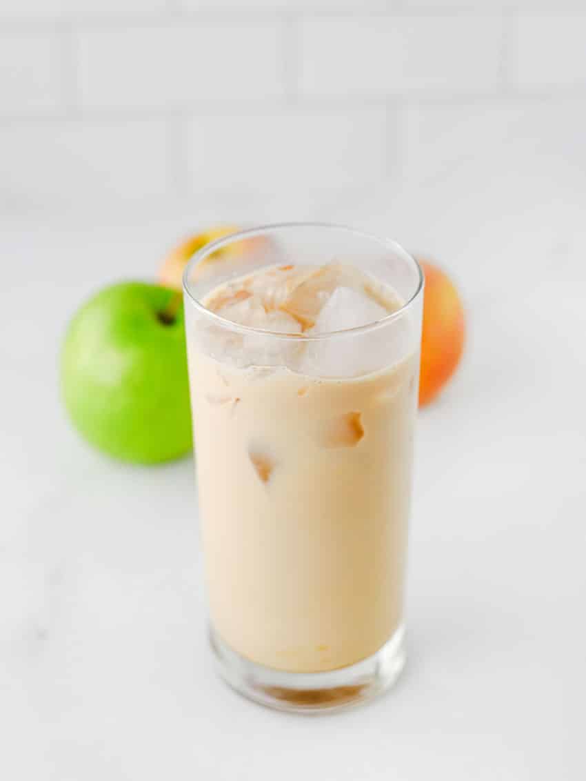 a homemade iced caramel apple latte in a small glass jar