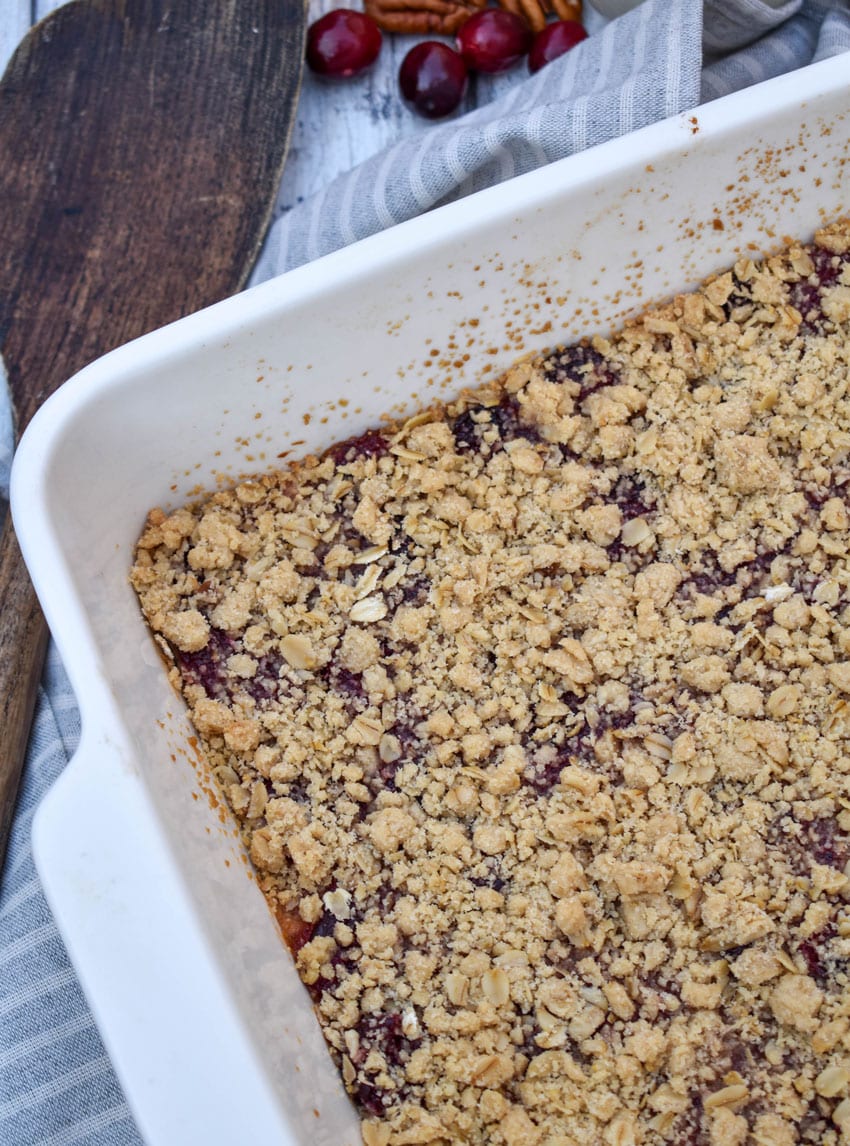 homemade cranberry crumble bars in a white square baking dish
