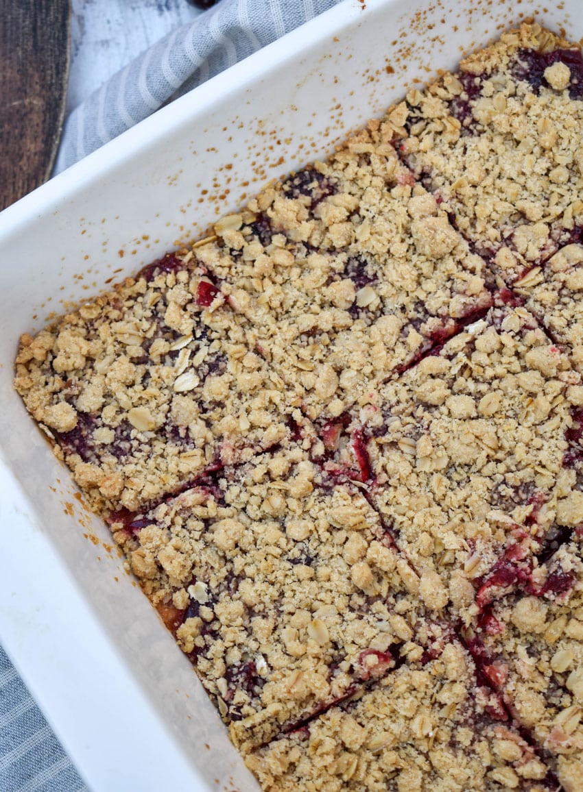 homemade cranberry crumble bars in a white square baking dish