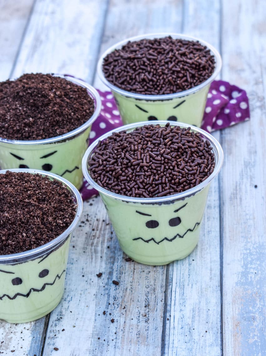 Frankenstein pudding cups on a wooden table