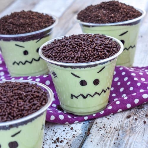 Frankenstein pudding cups on a wooden table