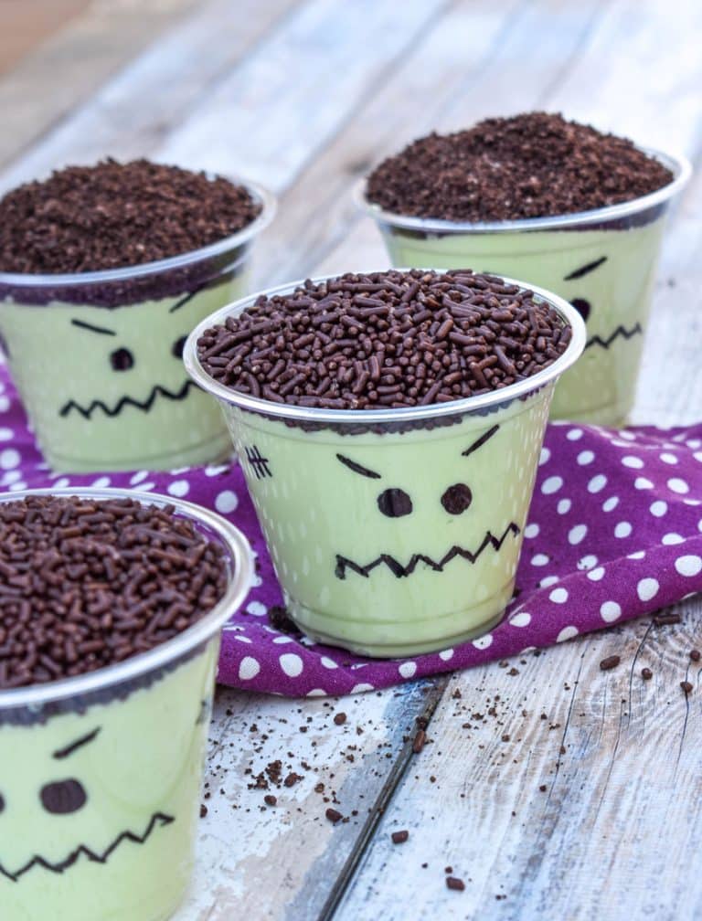 Frankenstein pudding cups on a wooden table
