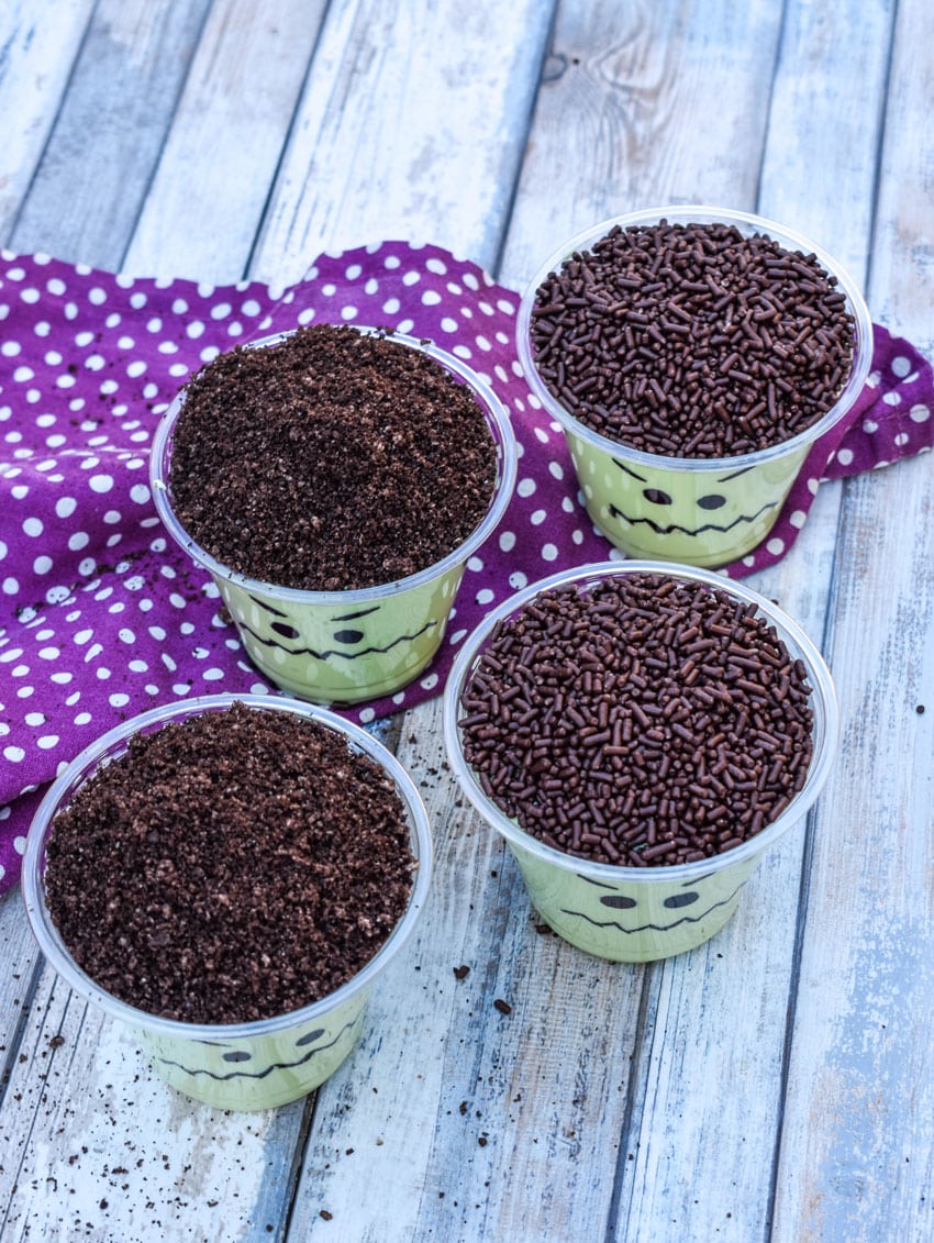 Frankenstein pudding cups on a wooden table