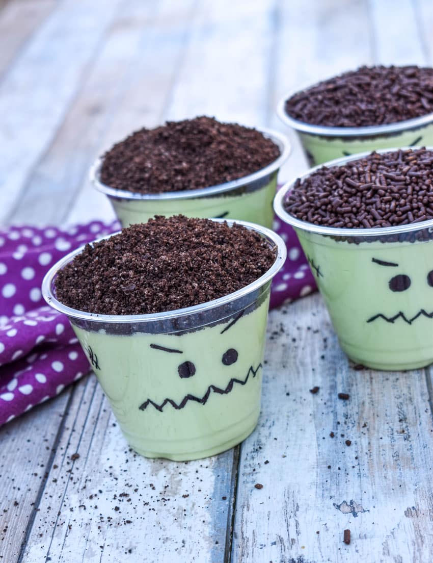 Frankenstein pudding cups on a wooden table
