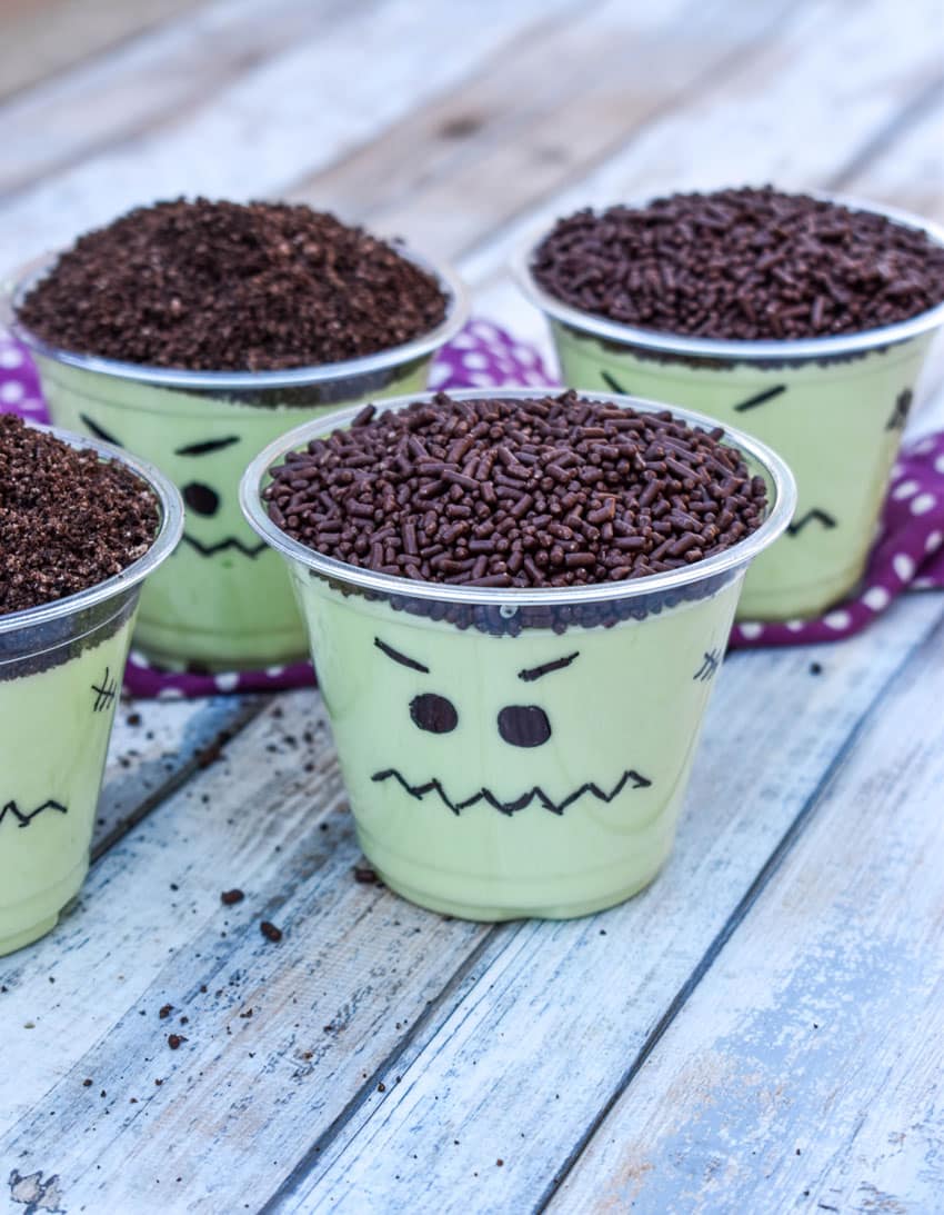 Frankenstein pudding cups on a wooden table