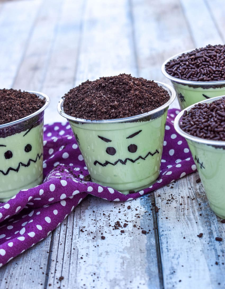 Frankenstein pudding cups on a wooden table