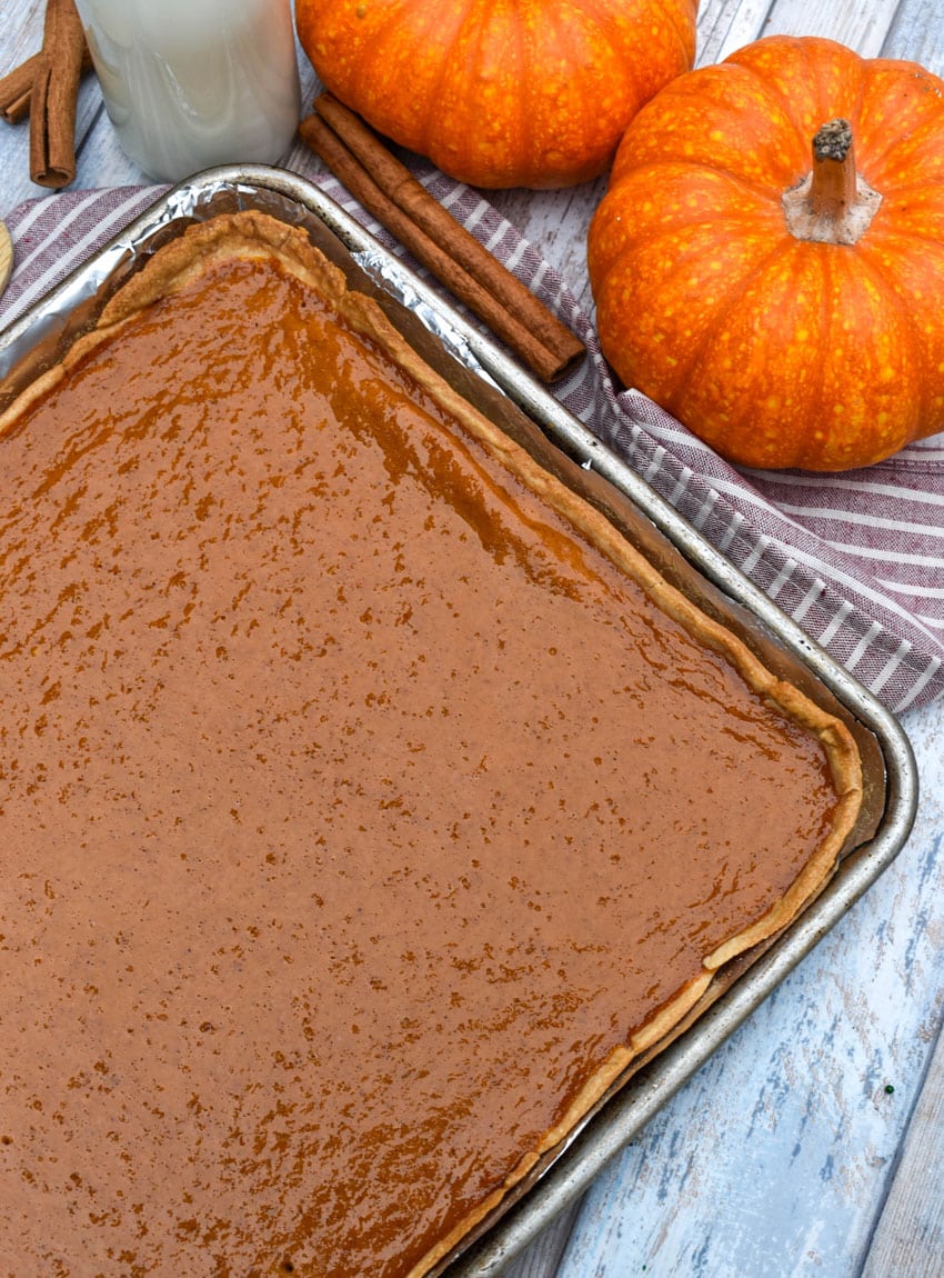 a pumpkin slab pie on a foil lined baking sheet