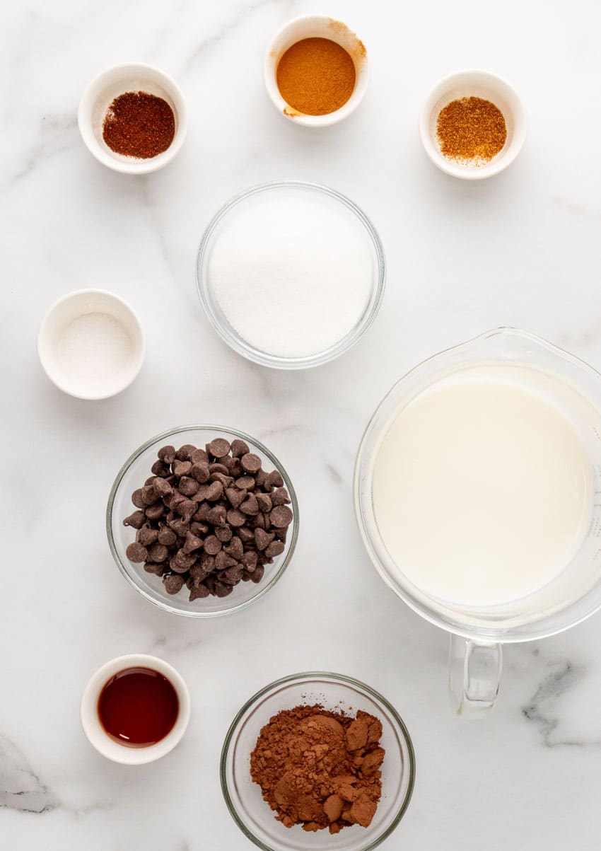 an overhead image showing the measured ingredients needed to make a batch of mexican hot chocolate