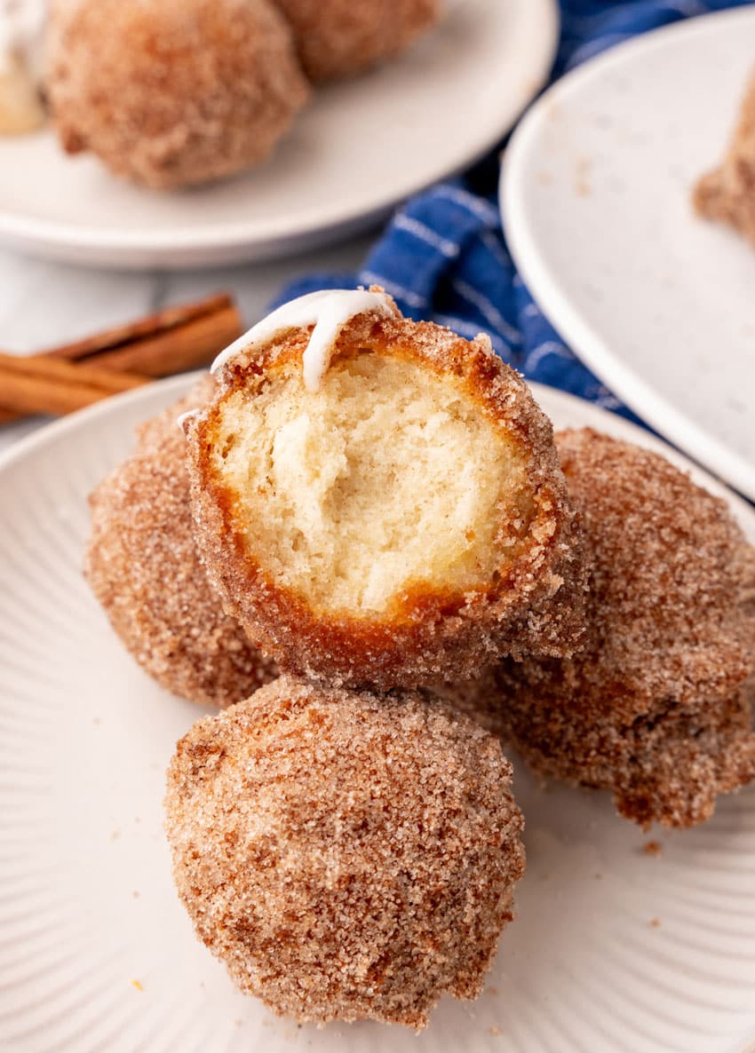 a stack of homemade pancake puppies on a small white plate