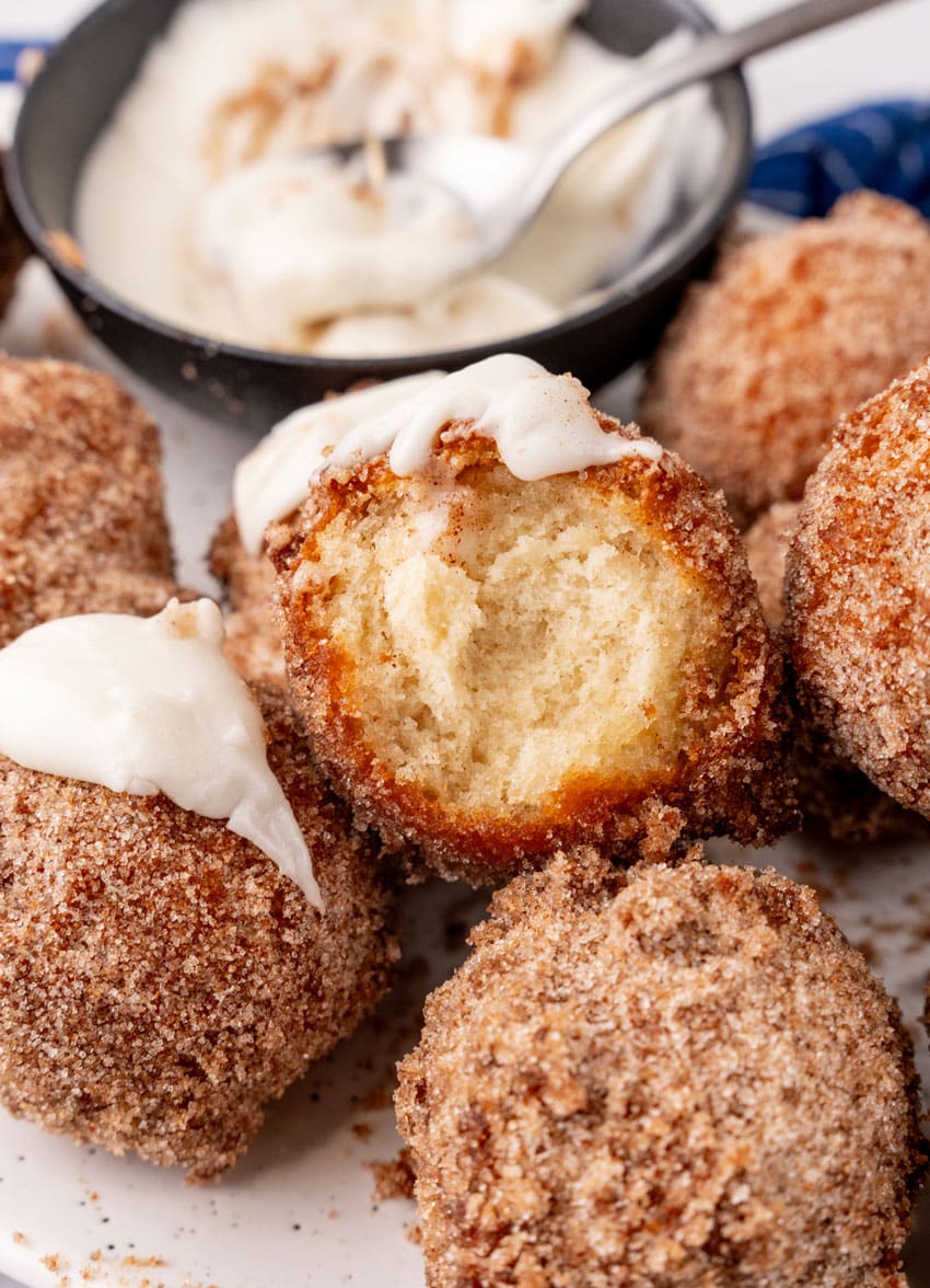 a stack of homemade pancake puppies on a small white plate