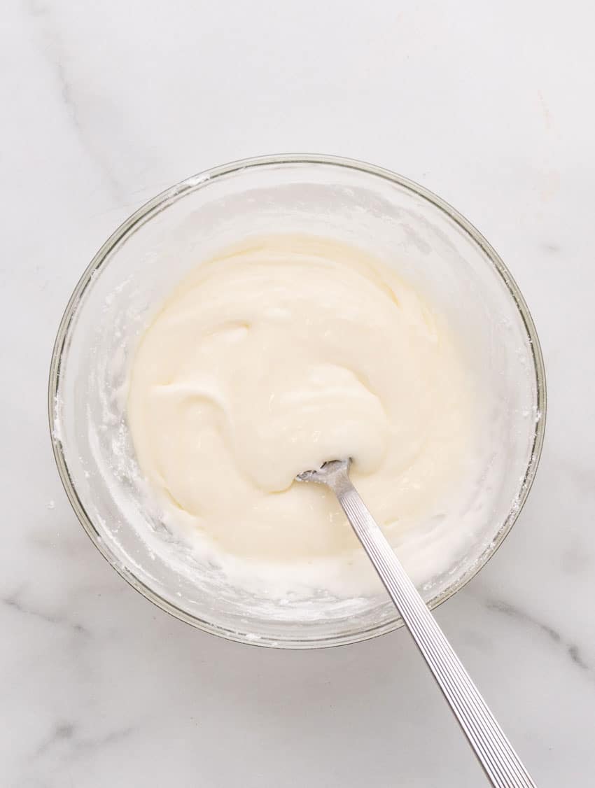pancake puppy batter in a glass mixing bowl