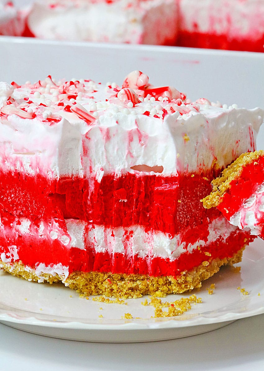 a slice of candy cane lush dessert on a small white dessert plate