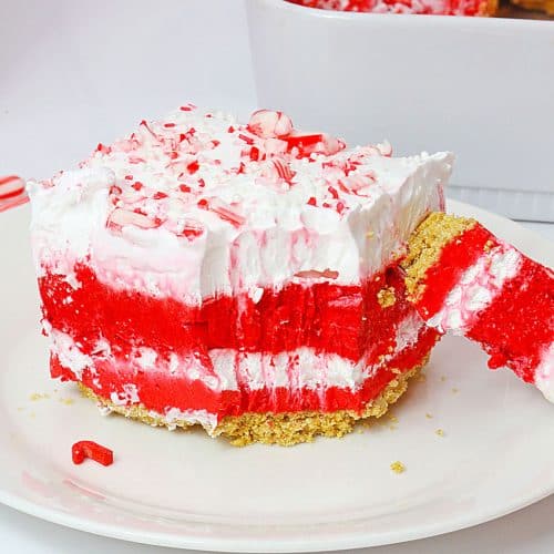 a slice of candy cane lush dessert on a small white dessert plate