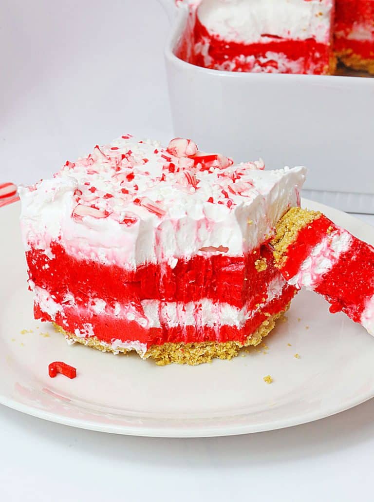 a slice of candy cane lush dessert on a small white dessert plate