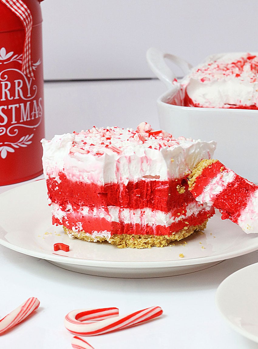 a slice of candy cane lush dessert on a small white dessert plate