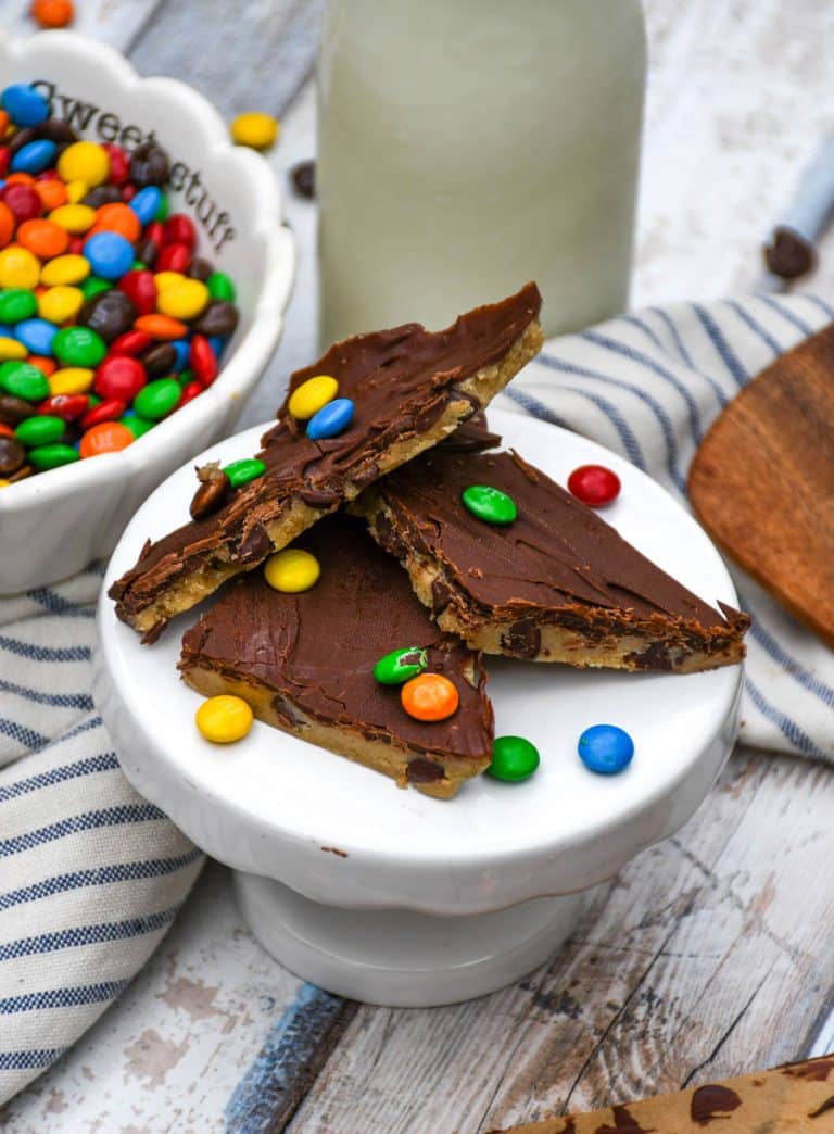 pieces of homemade cookie dough bark on a small white dessert stand
