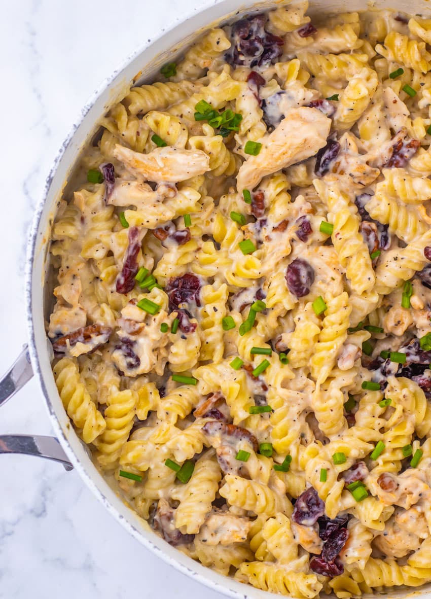 cranberry white cheddar chicken pasta in a large white skillet