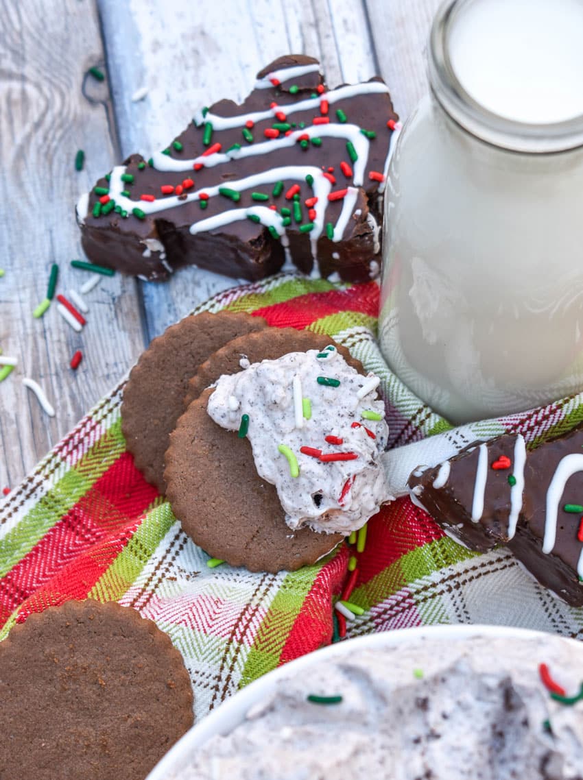 a hot cocoa flavored cookie topped with chocolate christmas tree cake dip