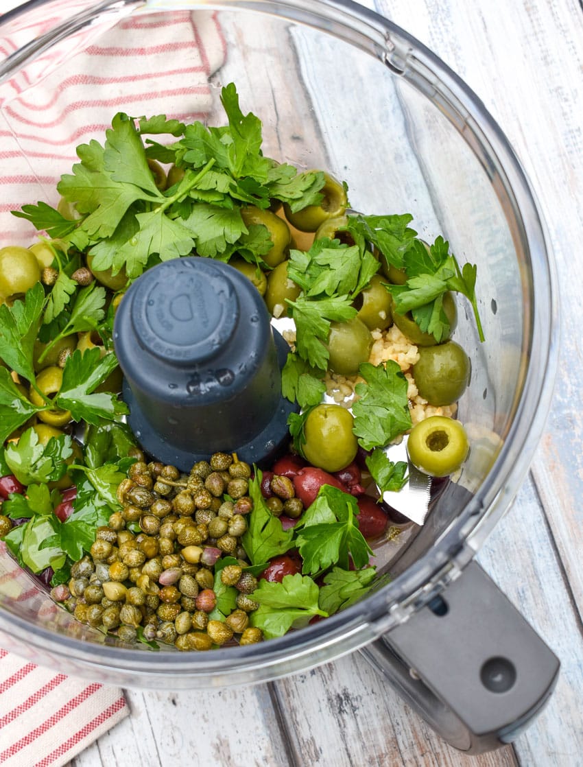 easy olive tapenade ingredients in the bowl of a food processor
